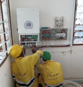 Two Buhrani Solar's workers are installing an electric system